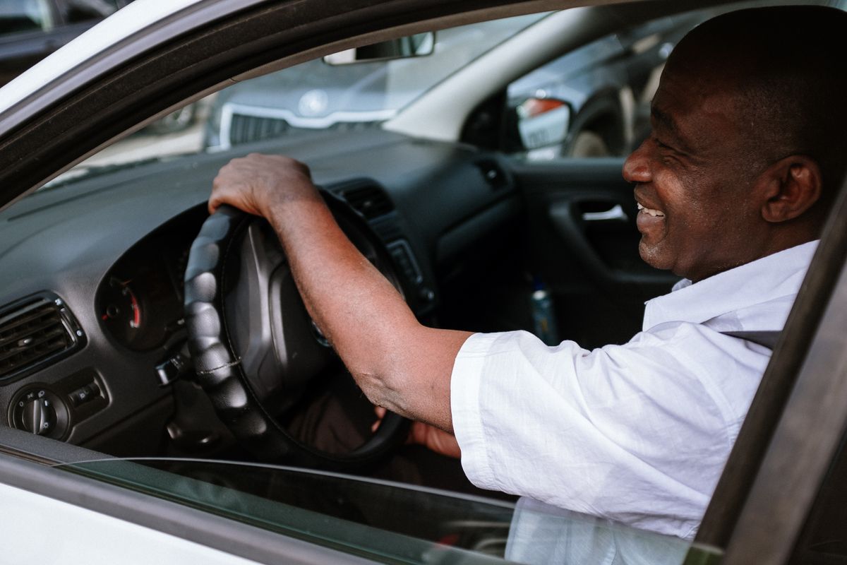 Driver laughing in the front seat of his car